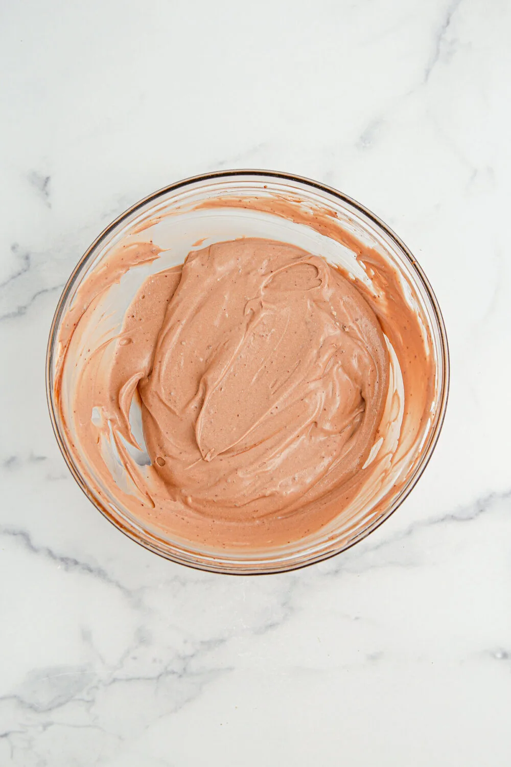 Chocolate pudding and whipped cream mixed in a bowl. 