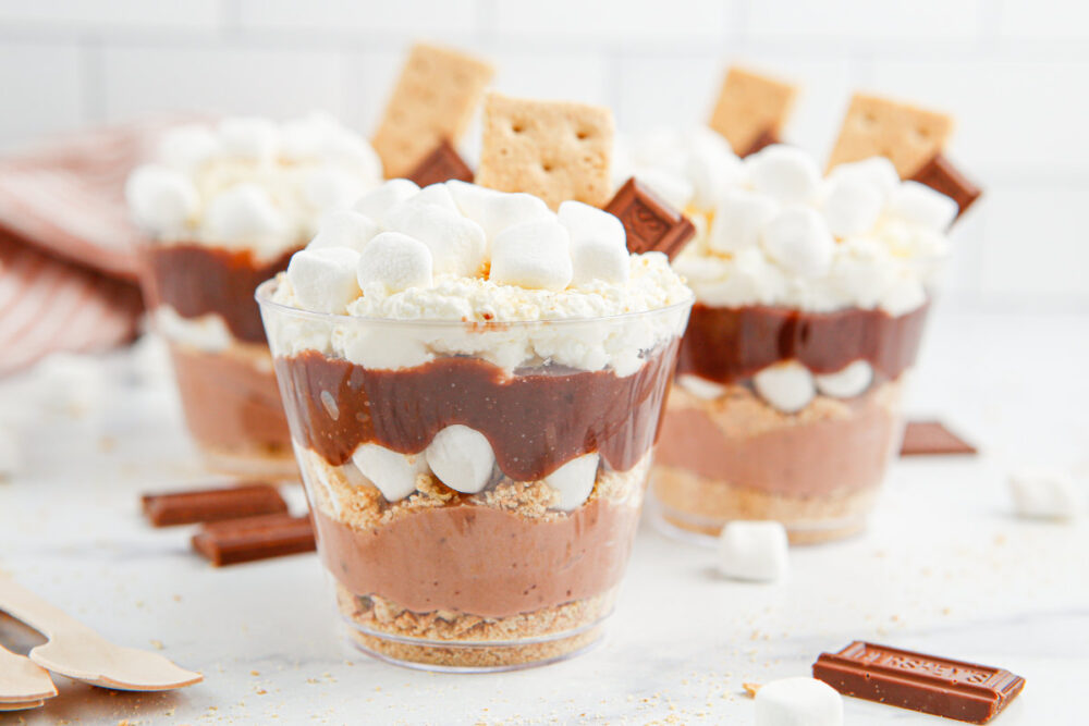 Layered pudding cups with chocolate pudding, marshmallows, whipped cream, and graham crackers. 
