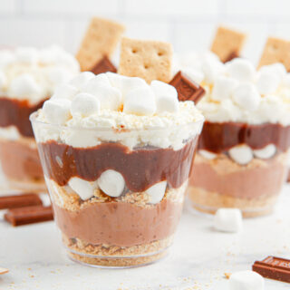Layered pudding cups with chocolate pudding, marshmallows, whipped cream, and graham crackers.