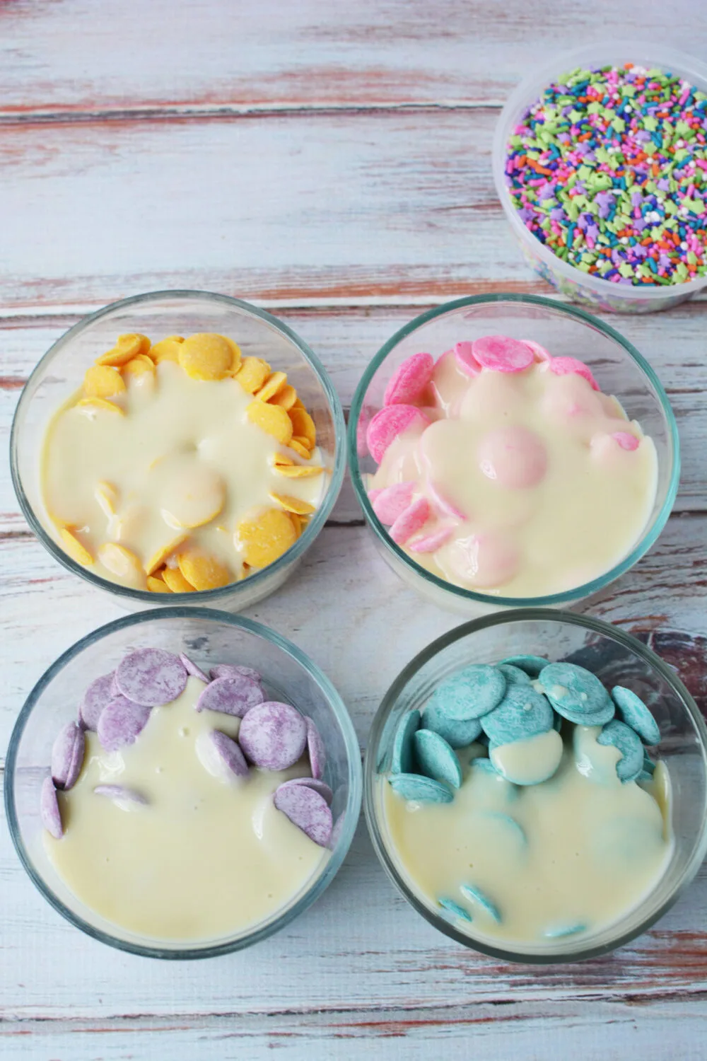 Candy melts in bowls with sweetened condensed milk. 
