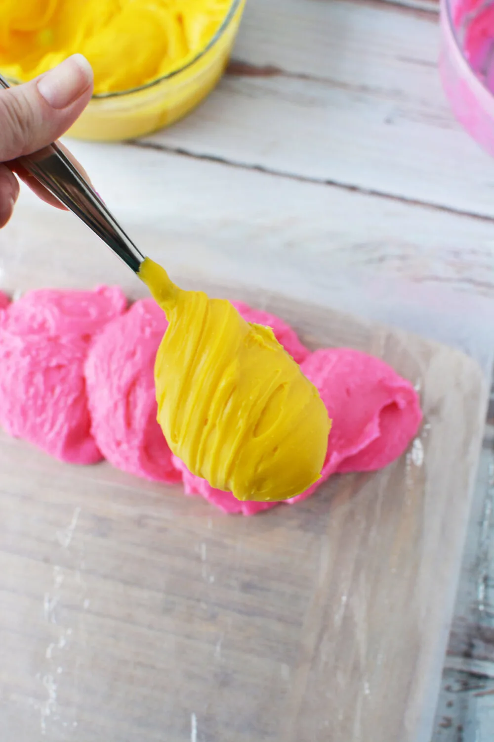 Adding different colors of fudge to a piping bag.