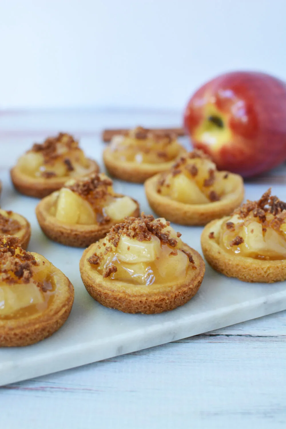 Apple pie filling cookies lined up on a board. 