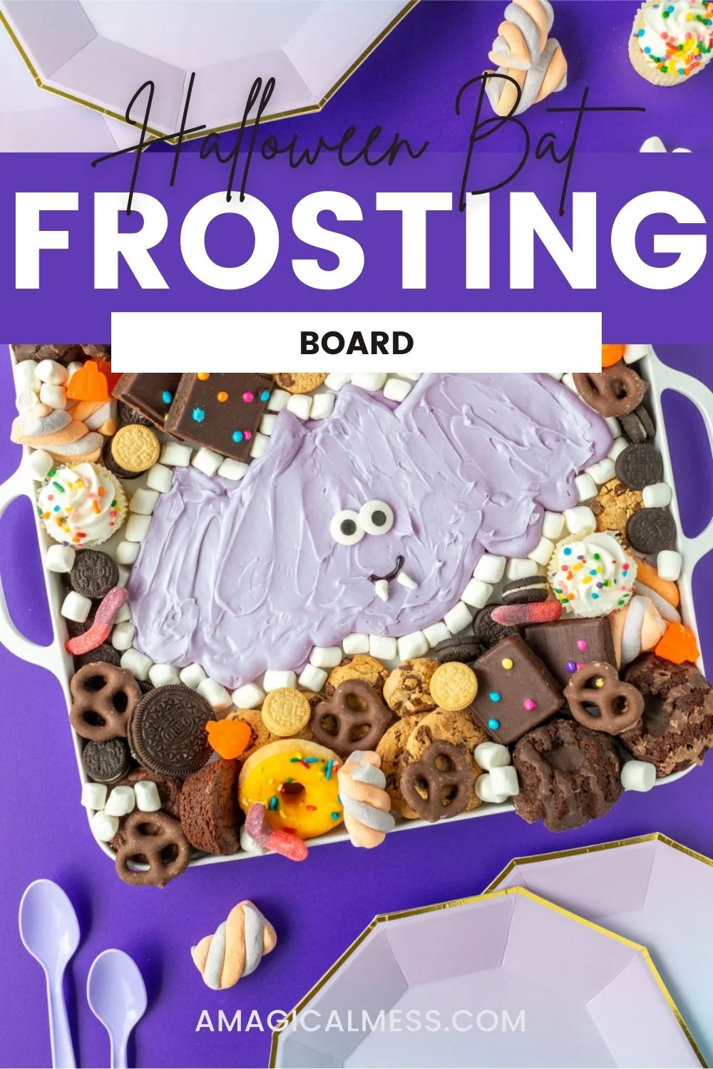 Bat frosting board with cookies, brownies, and other treats around a purple frosting bat. 