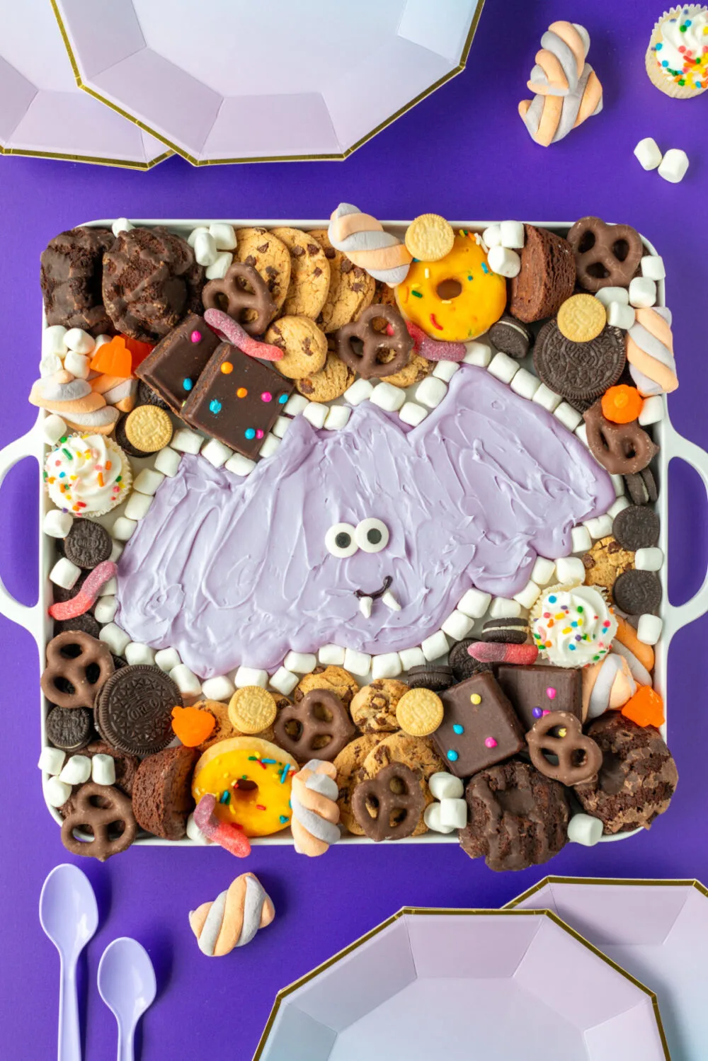 Purple bat buttercream board with purple plates and decor. 