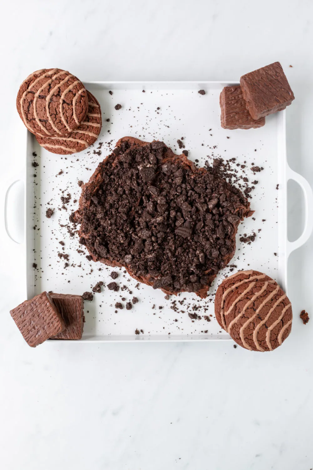 Adding cookies to graveyard frosting board.