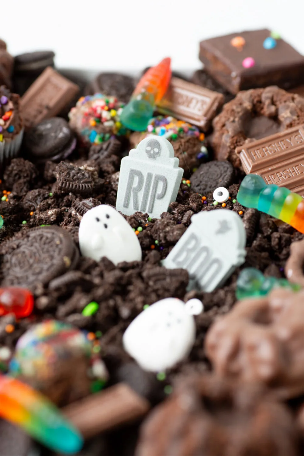Candy tombstones and ghosts in the graveyard frosting board. 