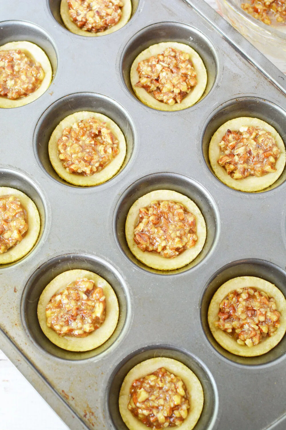 Muffin tins with pecan pie cookies. 