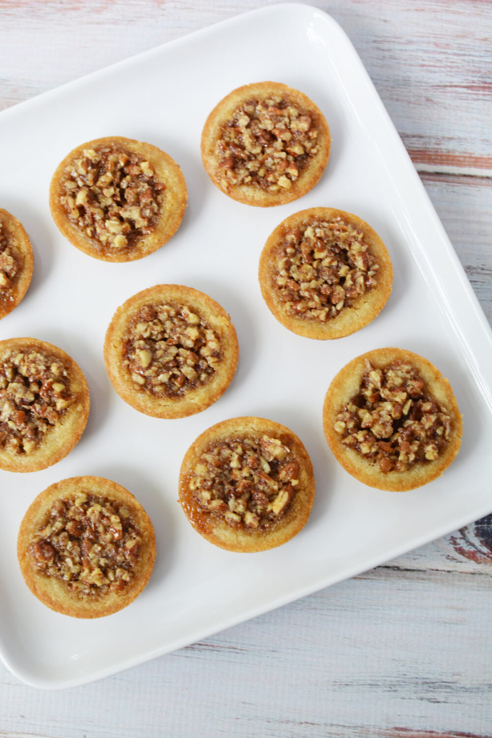 Pecan pie cookies on a white plate. 