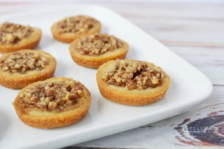 Pecan pie cookies on a white plate.