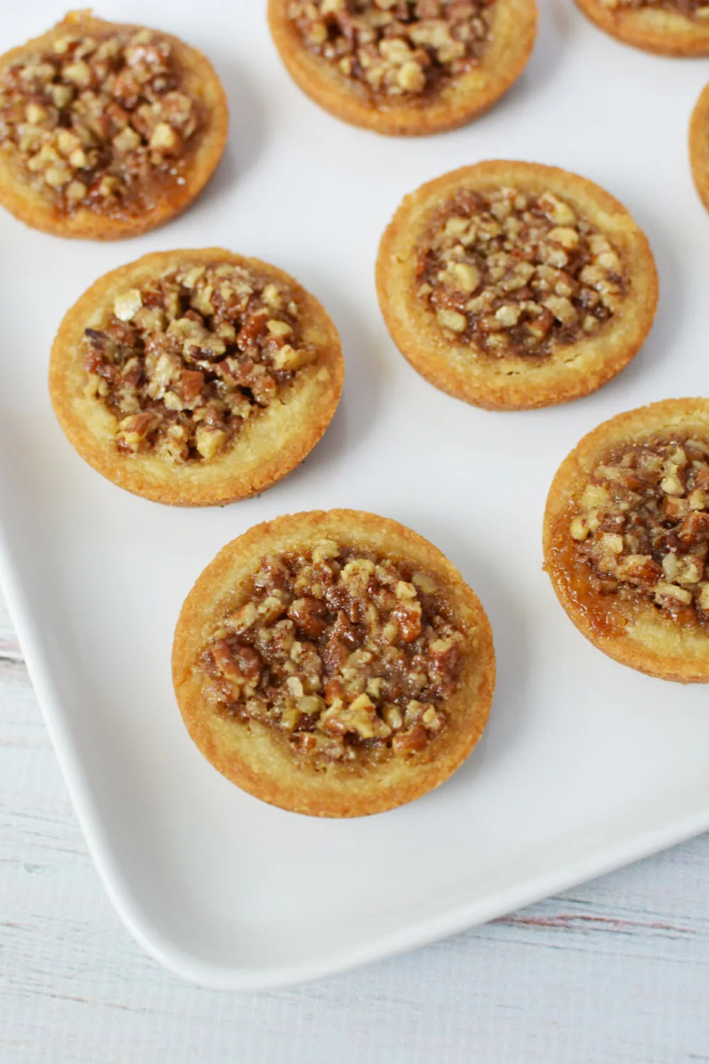Pecan pie cookies on a white serving tray. 