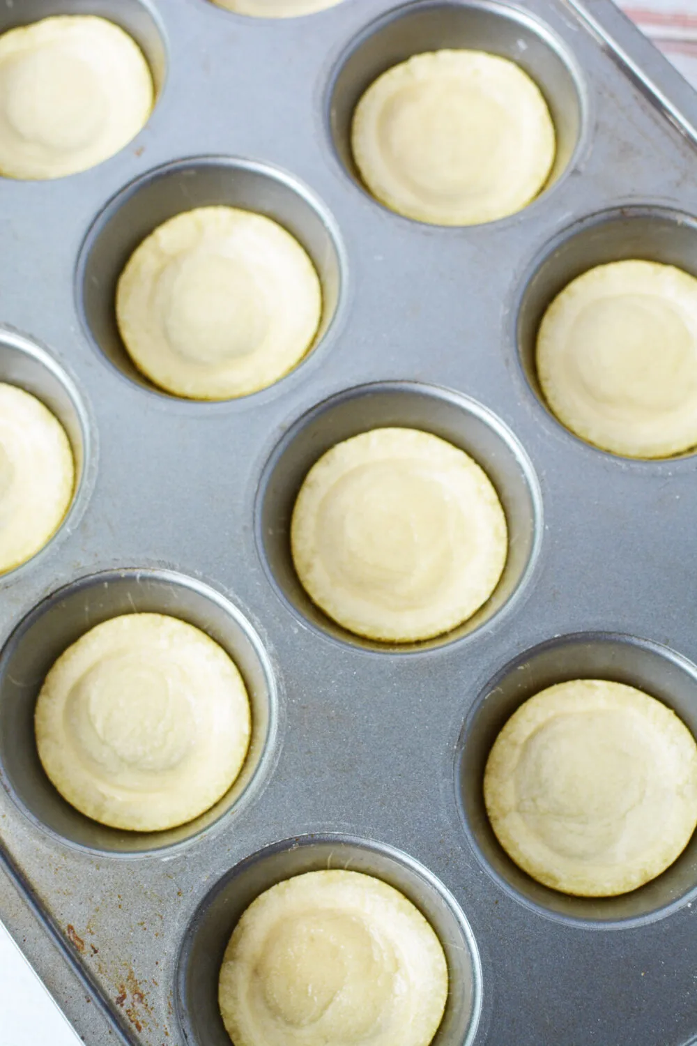 Sugar cookie dough in muffin tins.