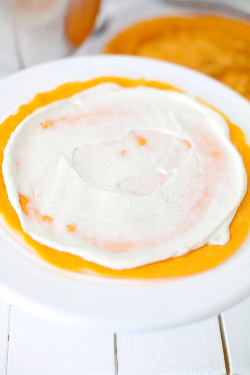 Cream cheese filling spread onto a pumpkin crepe. 