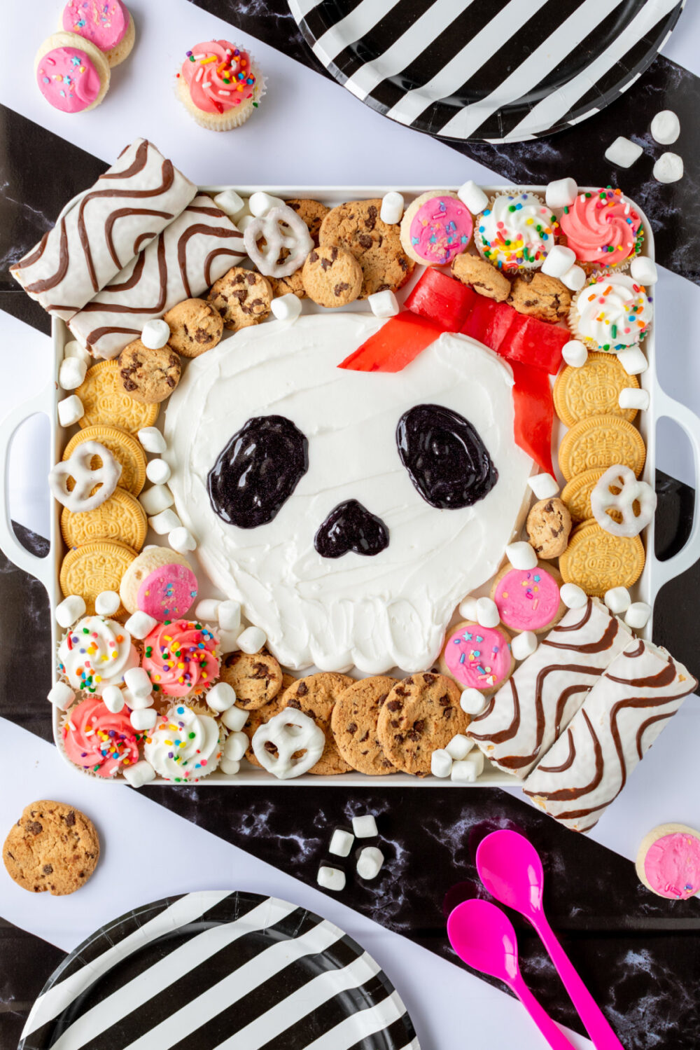 Skull frosting board on a striped background. 