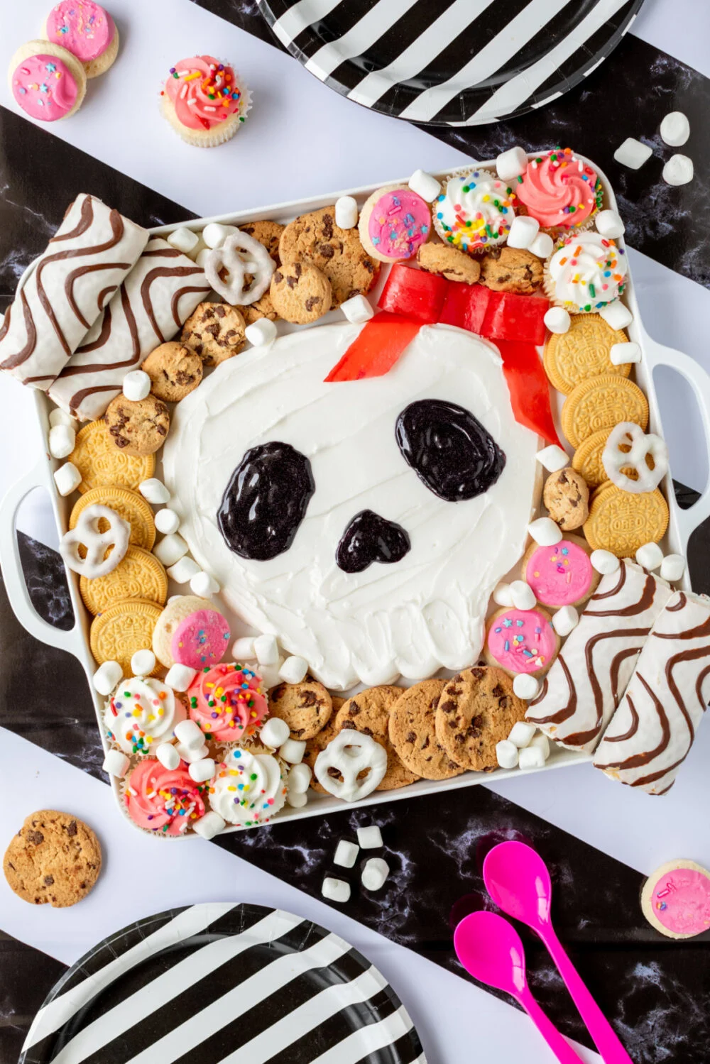 Skull Halloween frosting board on a striped background.