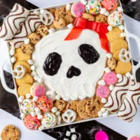 Skull Halloween frosting board on a striped background.