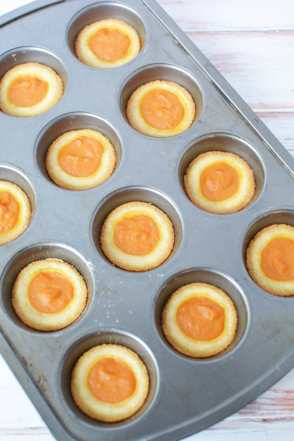 Baked pumpkin pie cookies still in the muffin tin.