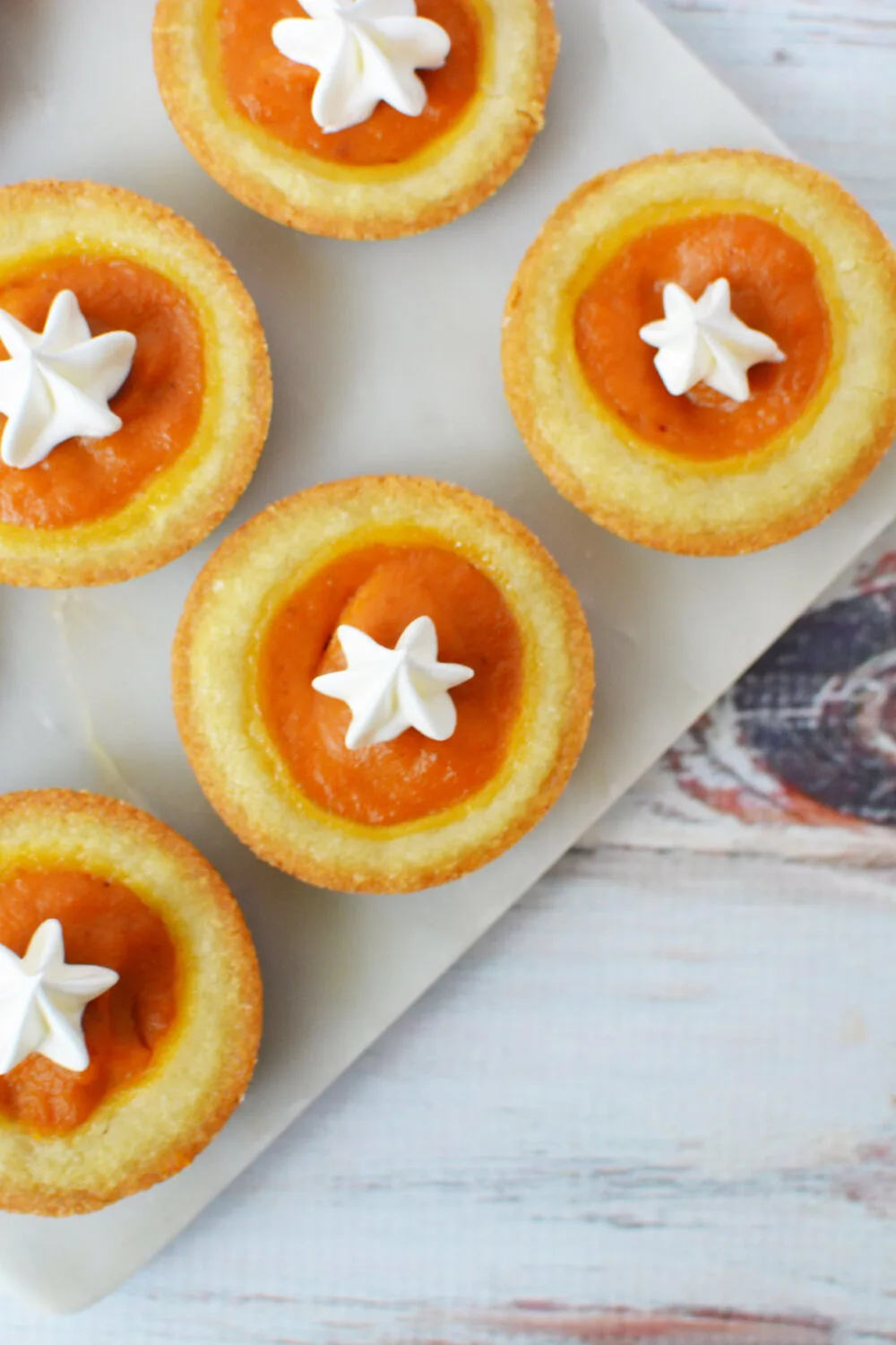 Pumpkin pies in cookie form topped with whipped topping.