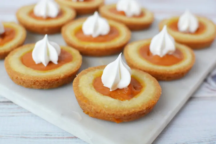 Pumpkin pie filling cookies with whipped cream toppings.