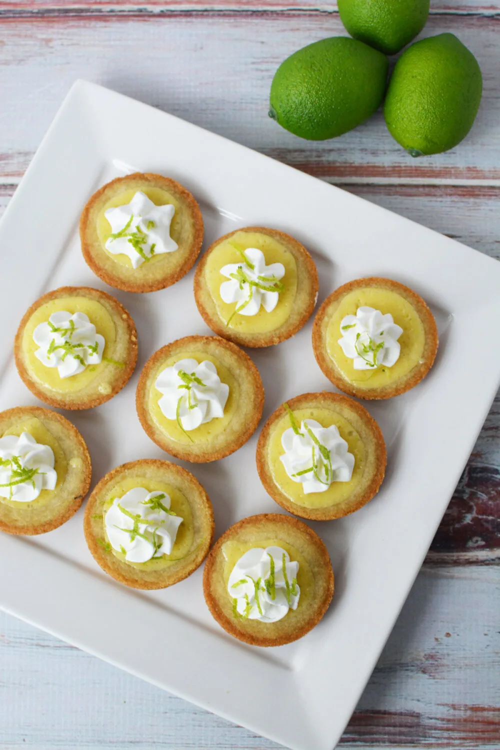Key lime pie cookies on a white serving tray. 