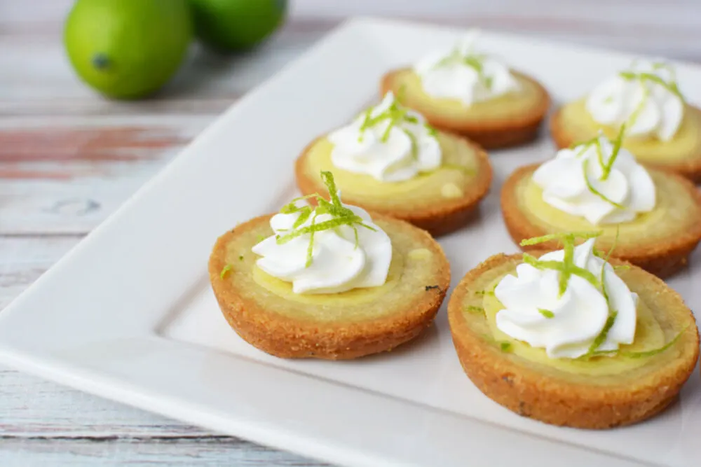 Key lime pie cookies on a white serving platter. 
