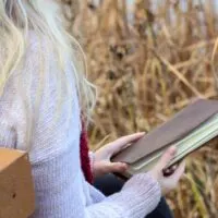 Girl outside with a journal.