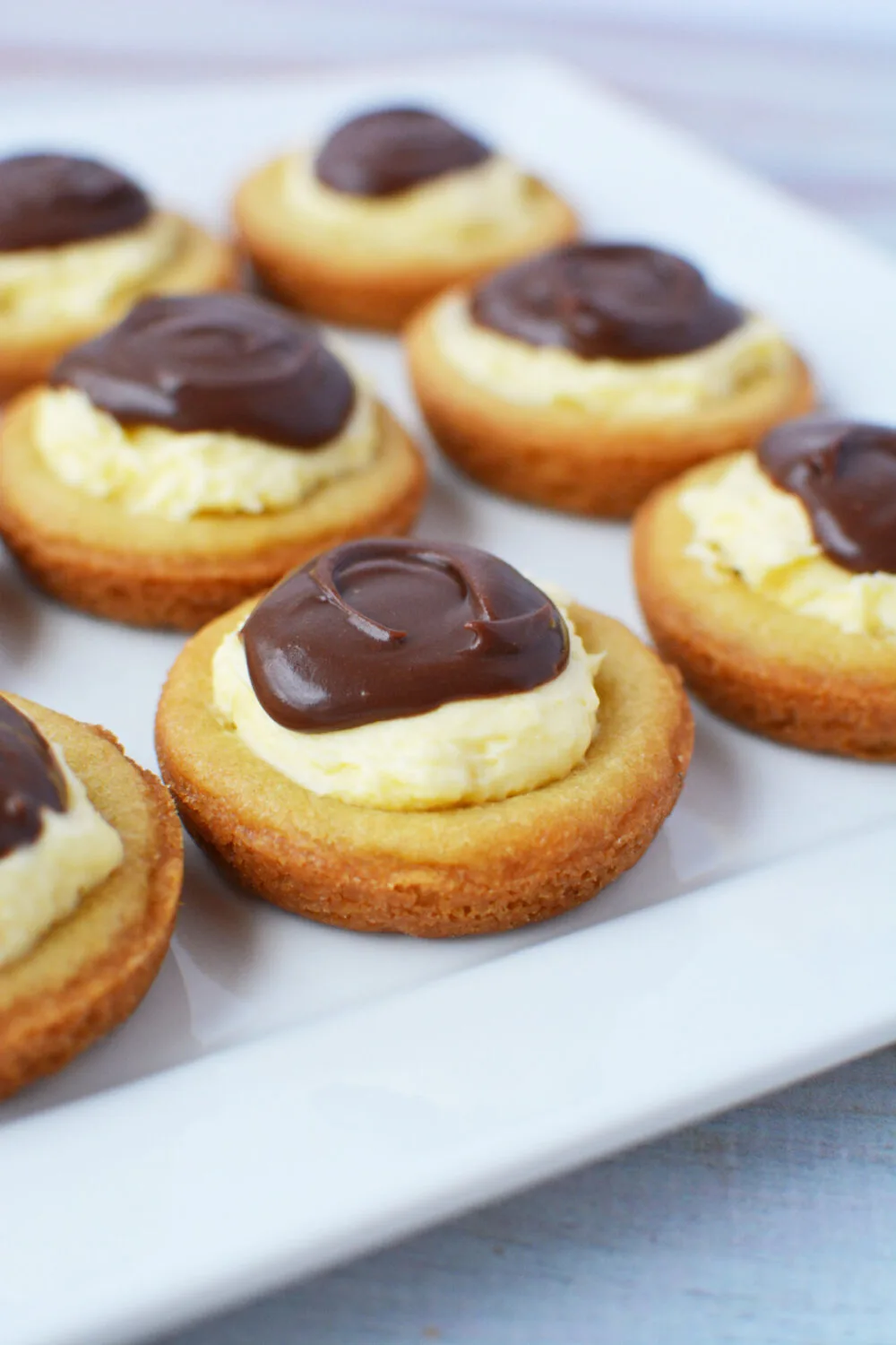 Plate of Boston custard pie cookies topped with chocolate. 