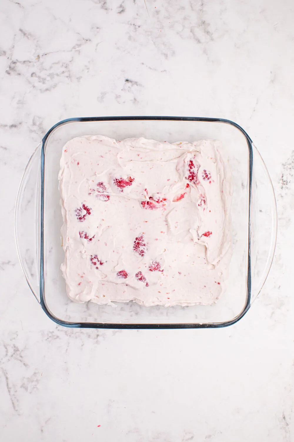 Raspberry whipped cream in a glass dish. 