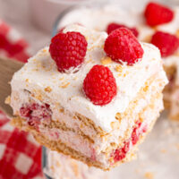 Top of a slice of a raspberry cream icebox cake as it's being lifted out of the pan.