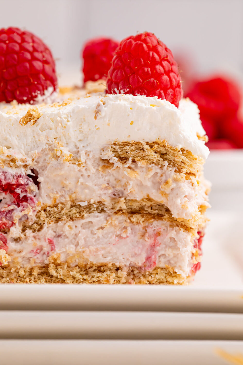 Closeup of layers of a slice of raspberry icebox cake. 