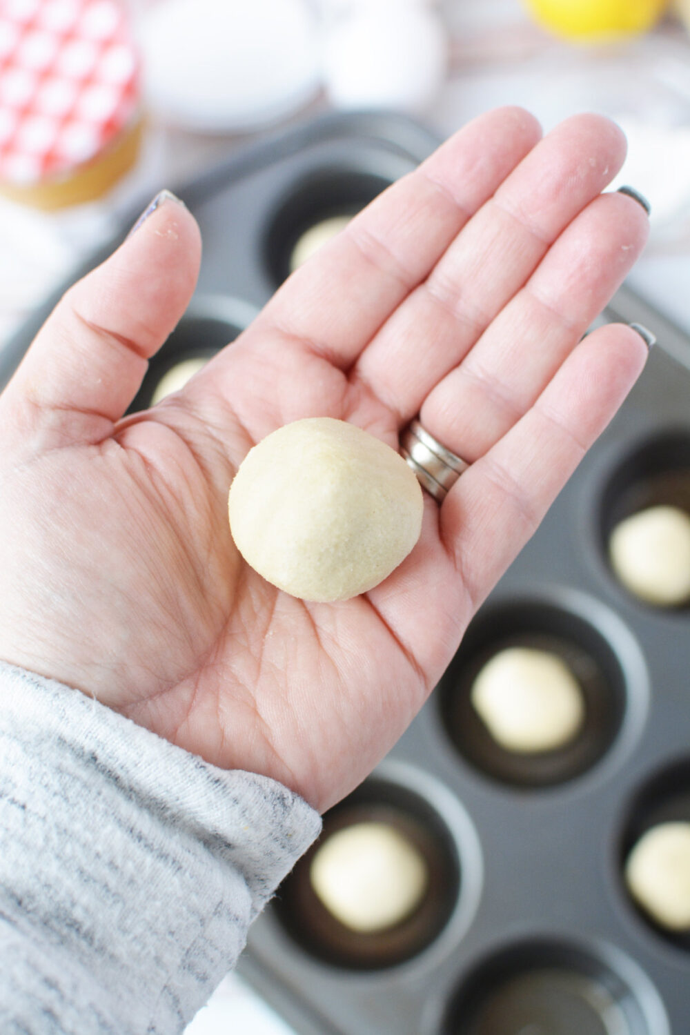 Holding a ball of sugar cookie dough. 