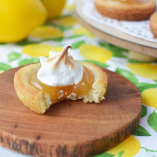 Lemon meringue cookie on a little wood coaster.