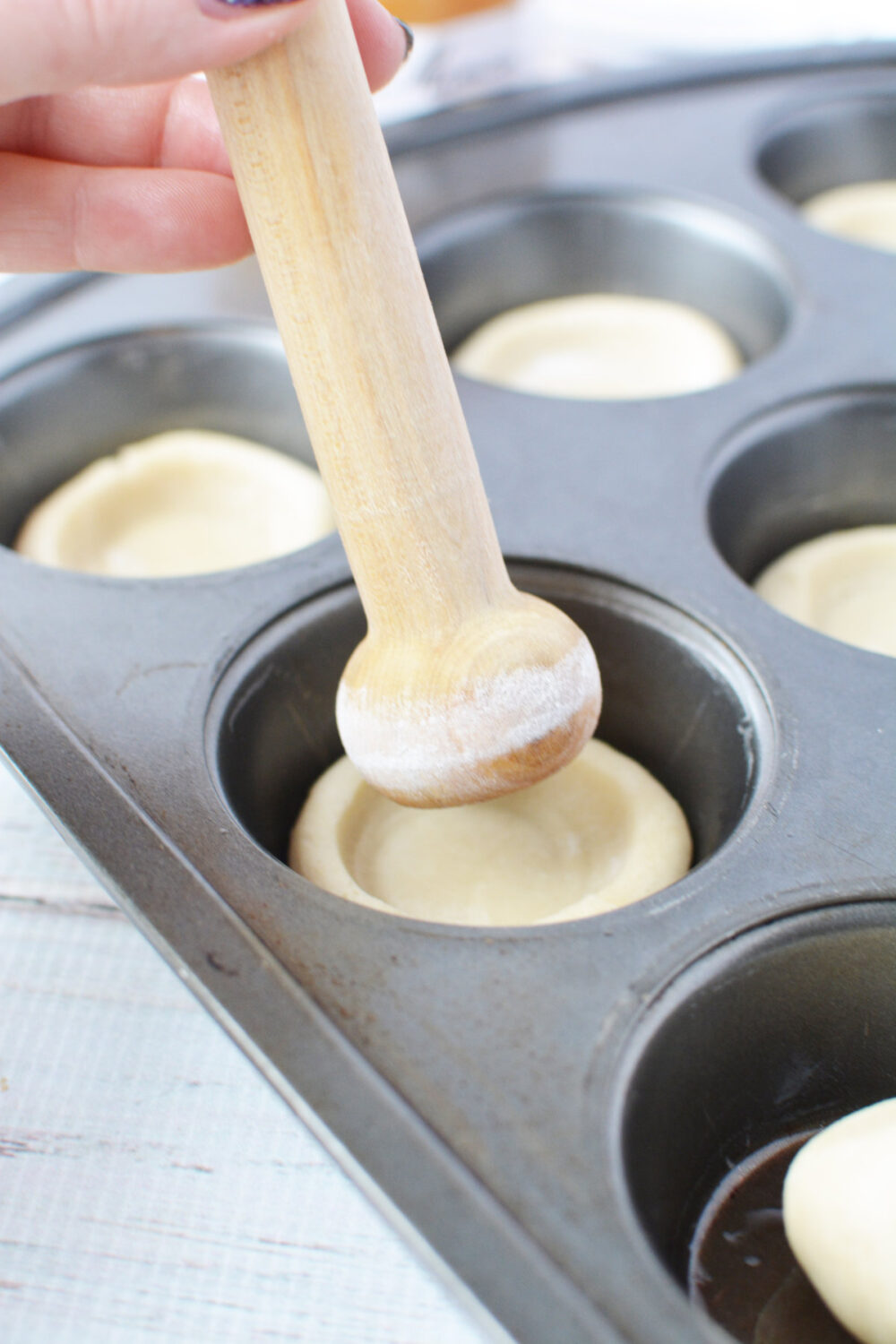 Shaping cookie dough with a tart shaper. 