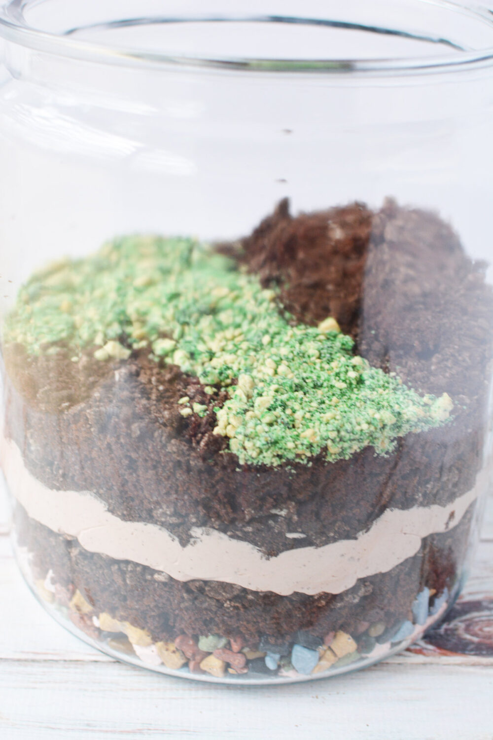 Green cookies in with other layers in a glass jar
