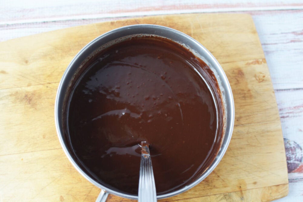 Stirring ganache in a small saucepan.