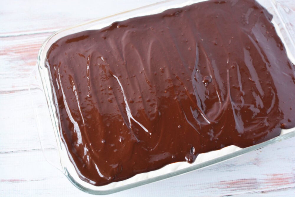 Ganache spread over eclair cake.