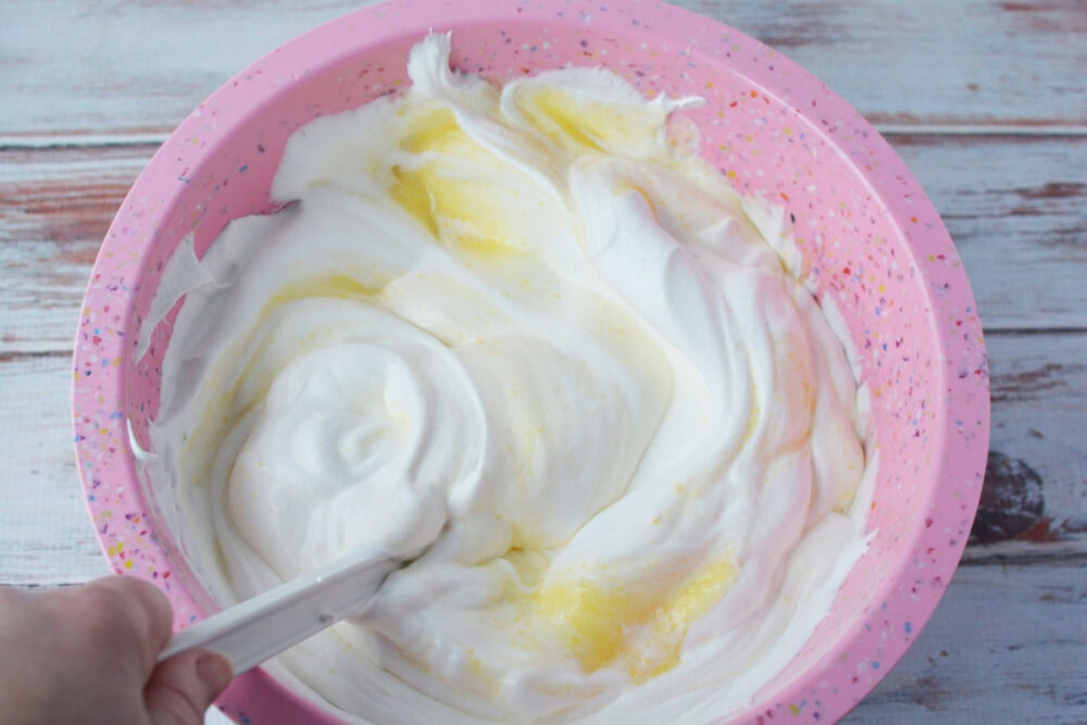 Mixing whipped topping into pudding. 