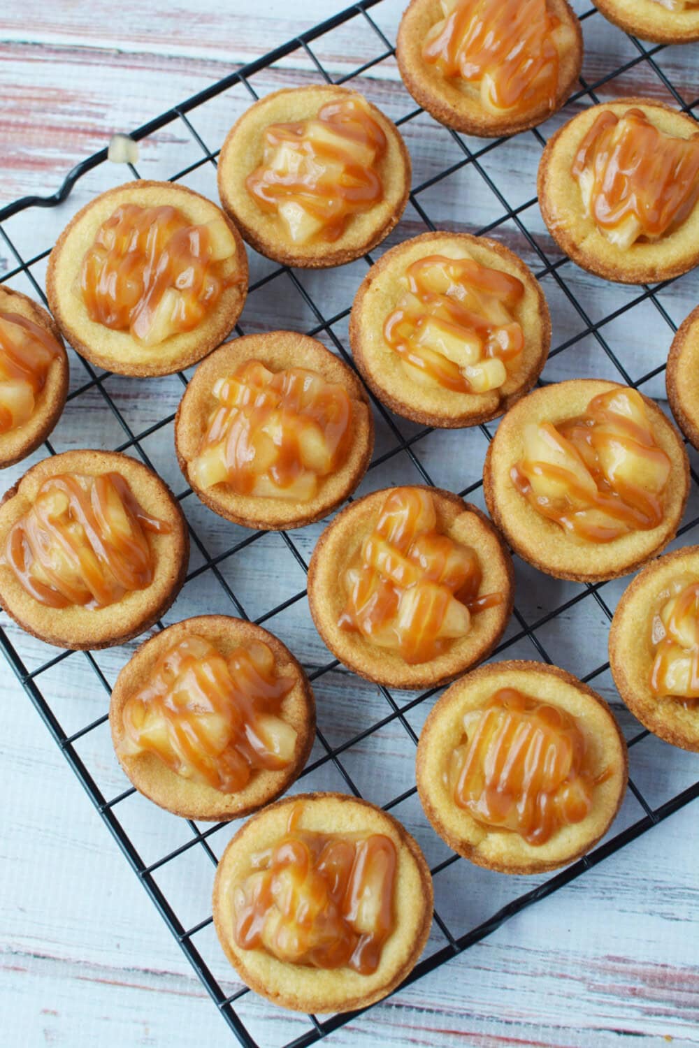 Caramel sauce drizzled onto apple pie cookies. 