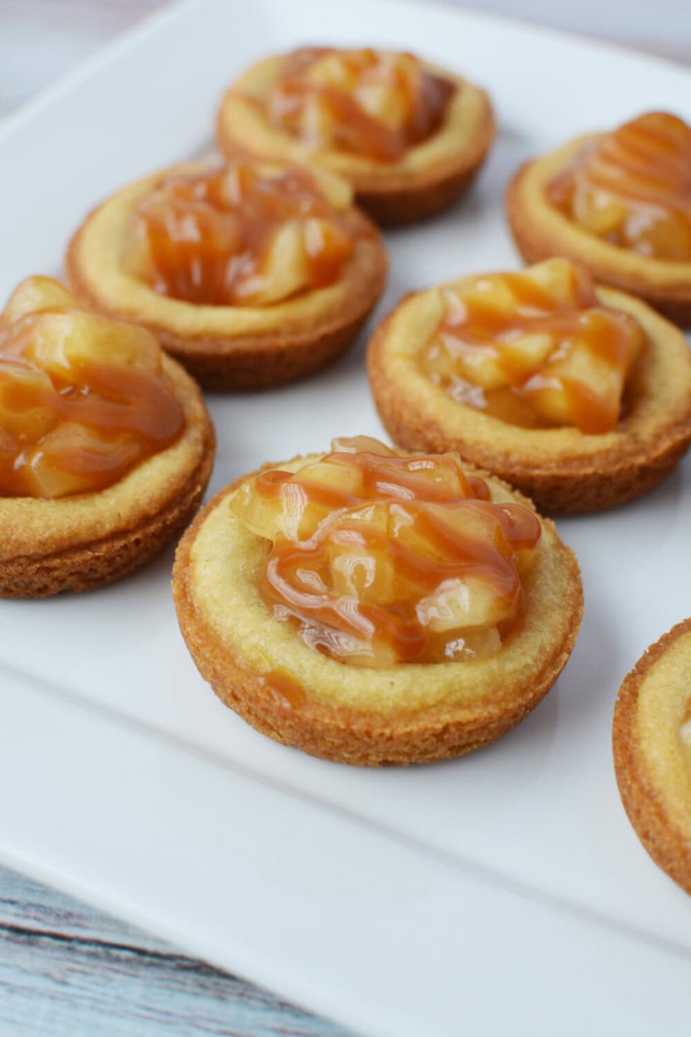 Caramel apple pie cookies on a white plate. 