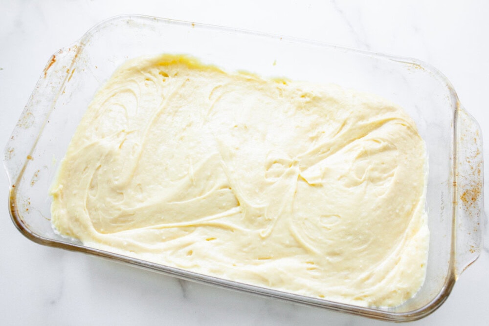 Cake batter base in a clear baking pan.