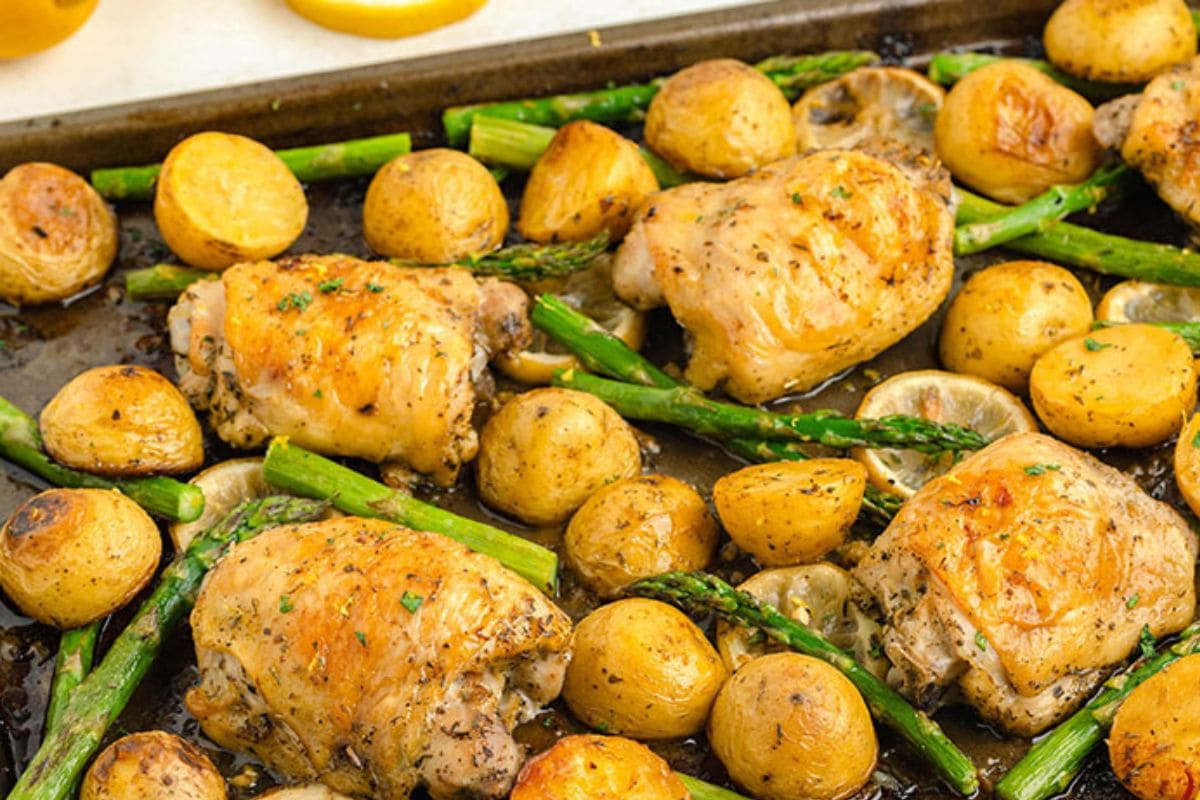 Sheet pan lemon chicken thighs with potatoes and veggies. 