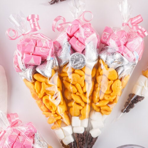 Pencil treat bags next to a bowl of chocolate chips.