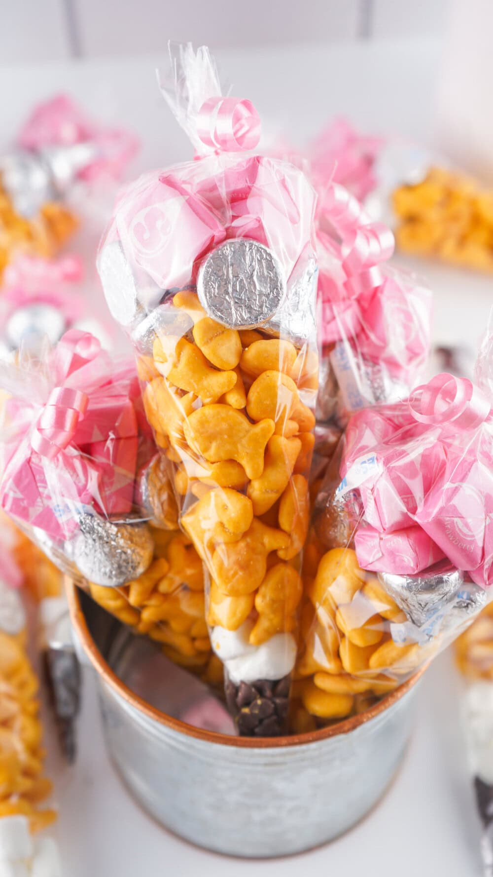 Bucket full of snack bags that look like pencils. 