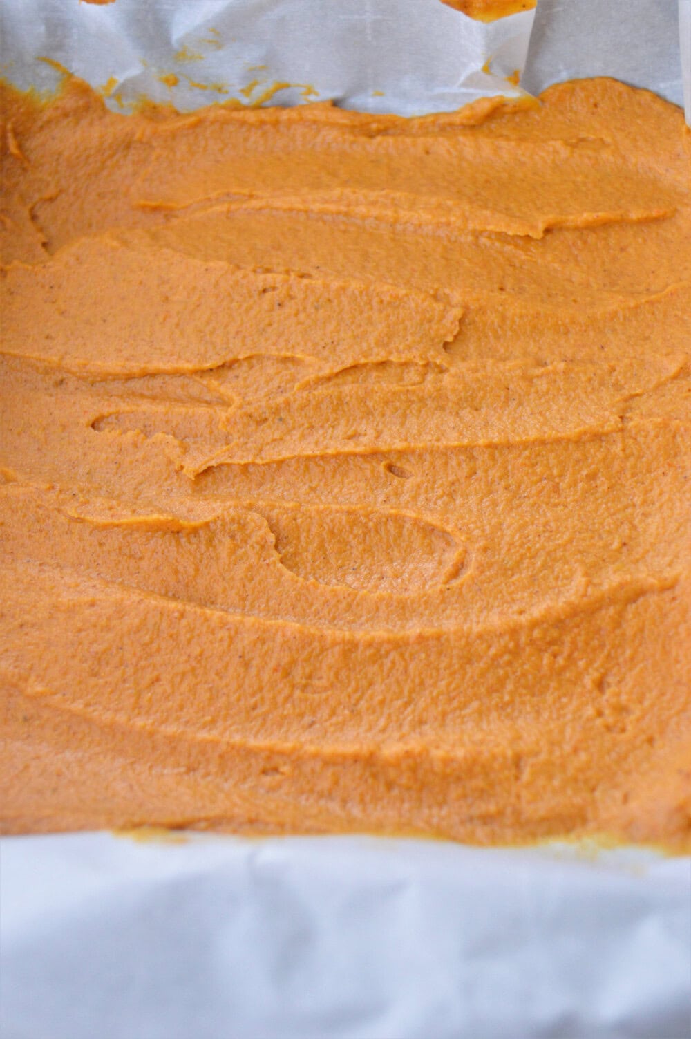 Peanut butter pumpkin fudge mixture in a pan.