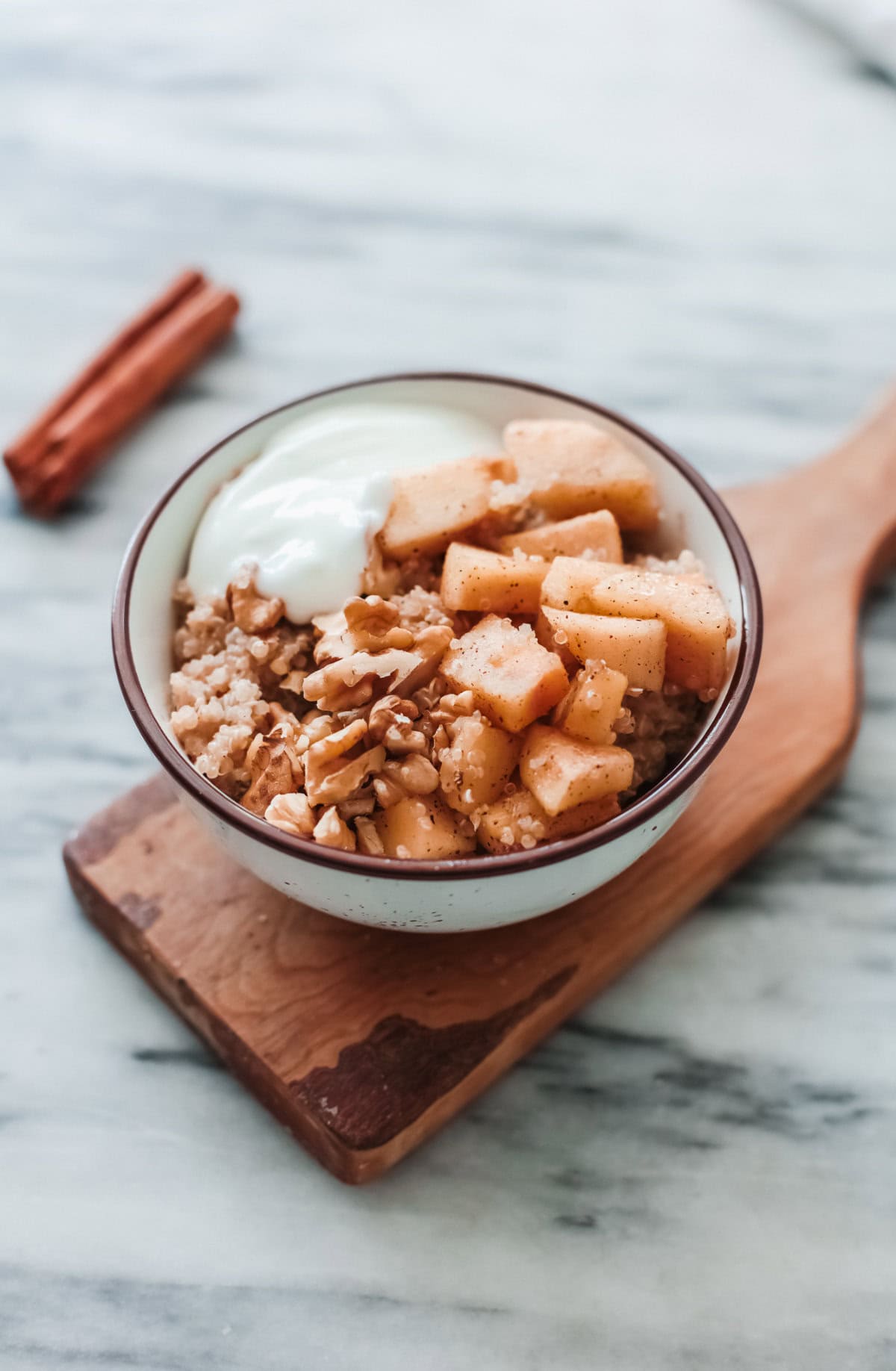 A bowl of quinoa with fruit and yogurt.