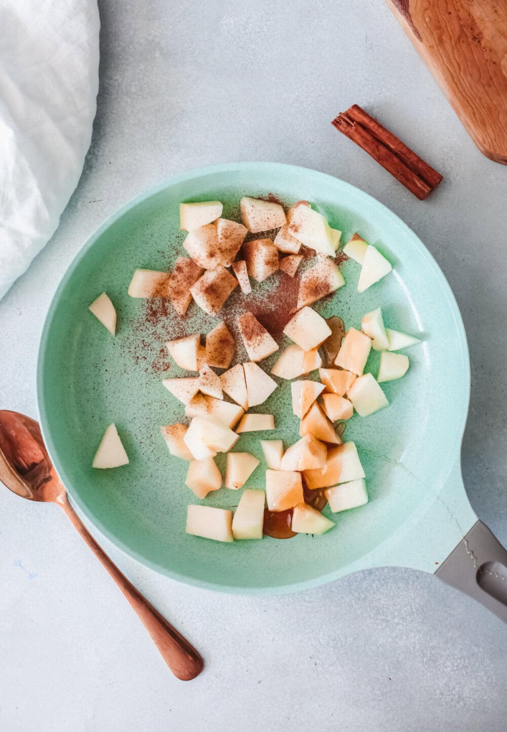 Diced apples and spices in a pan. 