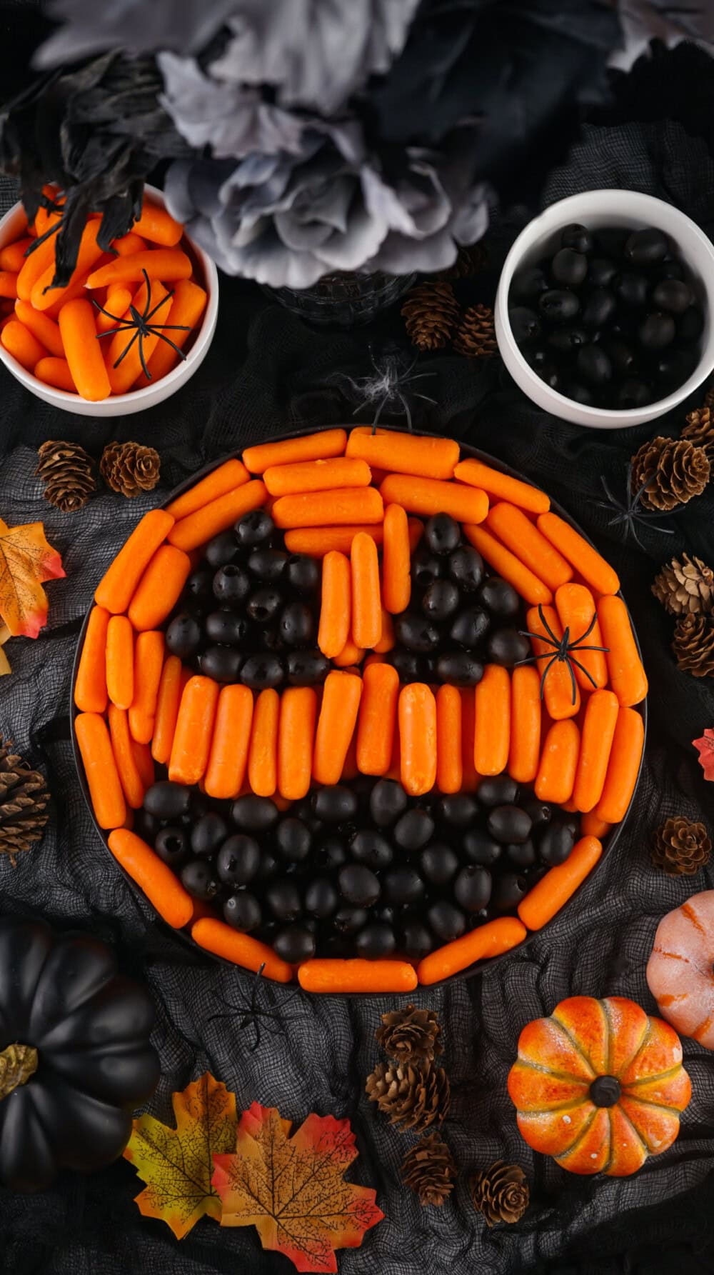 Jack-o-lantern veggie tray made with carrots and olives. 