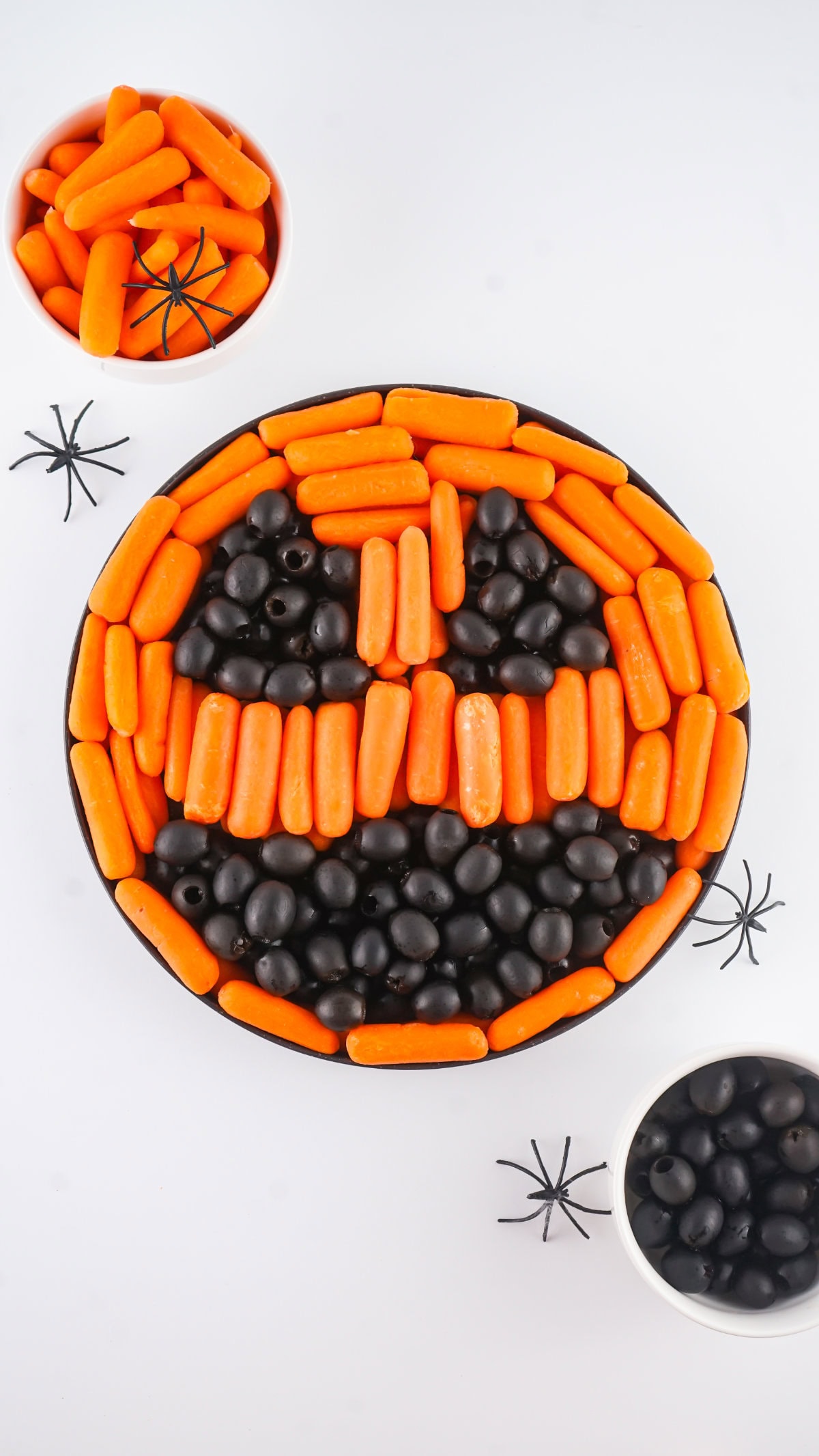 Carrots and olives appetizer that looks like a pumpkin face.