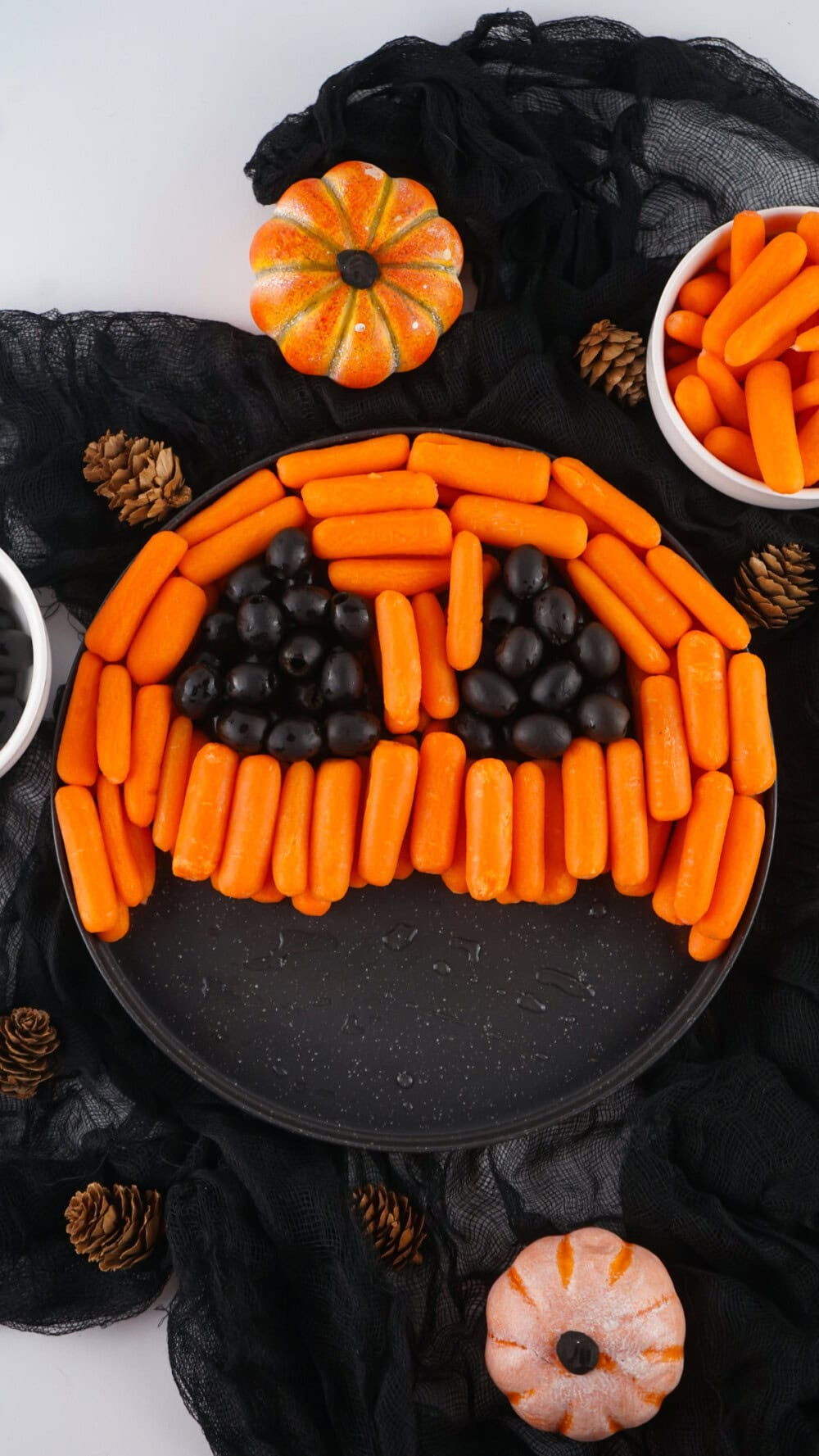 Making a pumpkin face out of baby carrots and olives. 