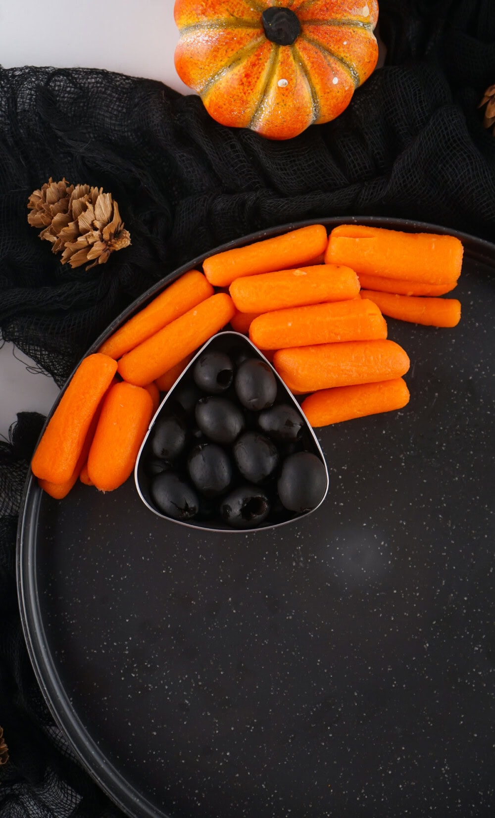 Baby carrots around olives. 