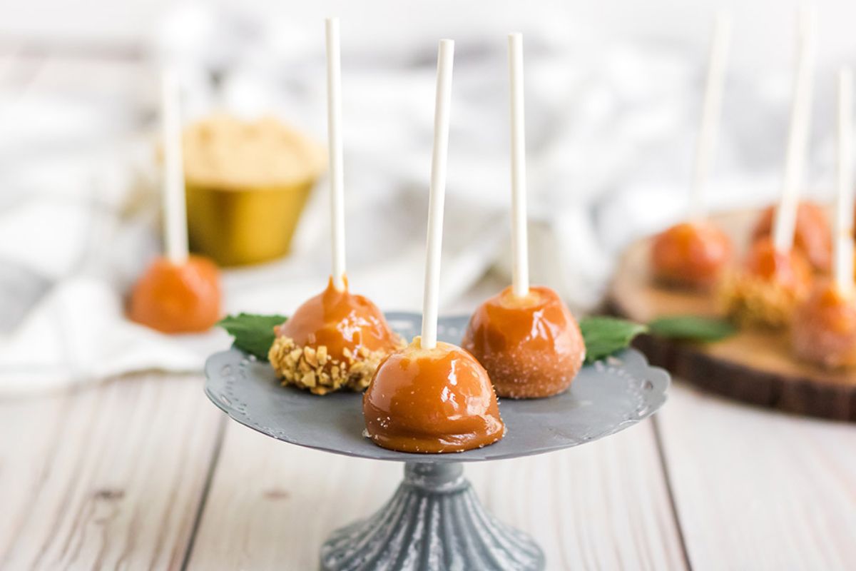 Mini caramel apples with different toppings on a display. 